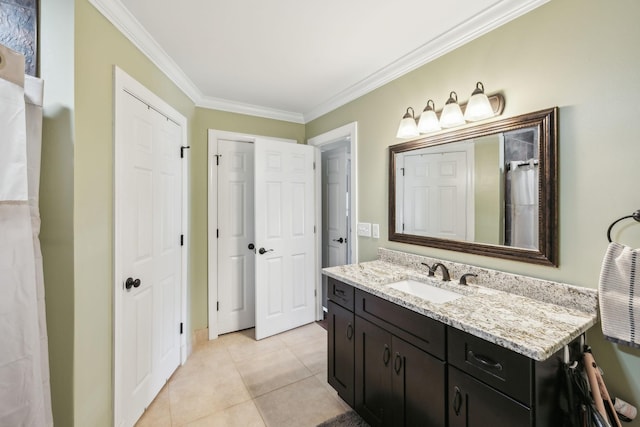 bathroom featuring tile patterned floors, crown molding, and vanity