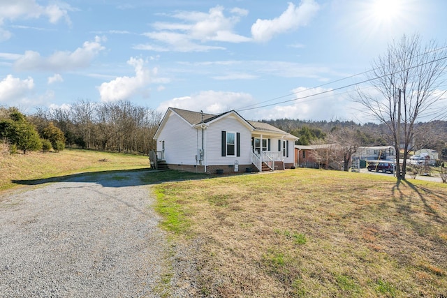 view of front of house featuring covered porch and a front yard