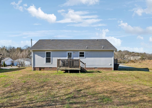 rear view of property featuring a wooden deck and a yard