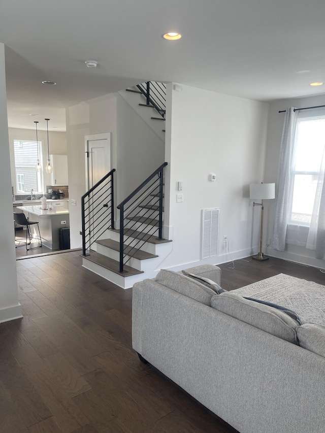 living room with dark hardwood / wood-style flooring