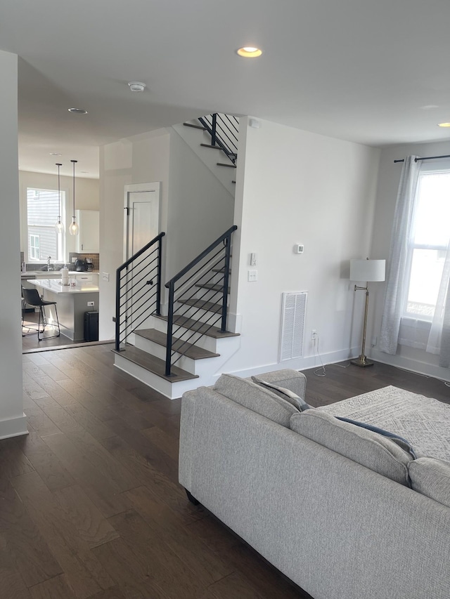 living room with dark wood-type flooring and sink