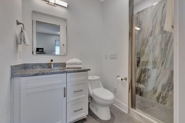 bathroom with tile patterned floors, vanity, an enclosed shower, and toilet