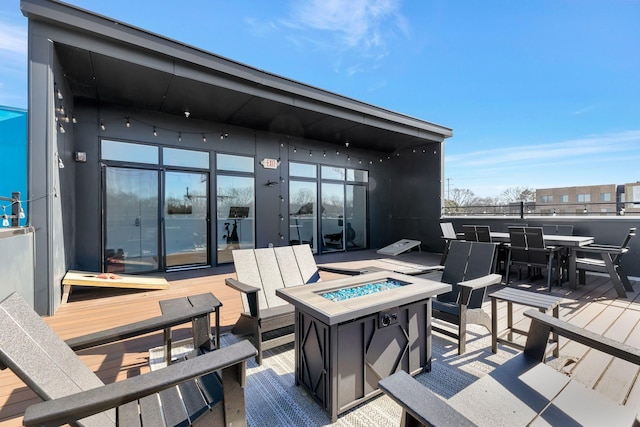 view of patio / terrace featuring a wooden deck and a fire pit