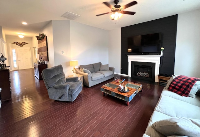 living room featuring ceiling fan and dark hardwood / wood-style floors