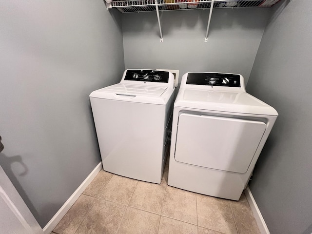 washroom featuring light tile patterned floors and independent washer and dryer