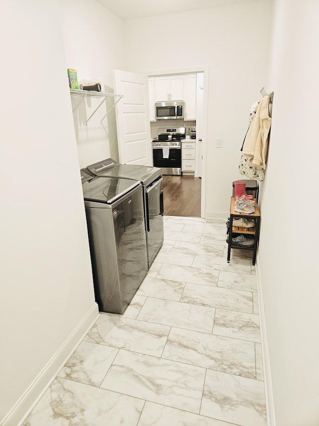 1528 Cedarbrooke Ln, Lebanon, TN 37090 - laundry room with washer and clothes dryer and light marble finish floors