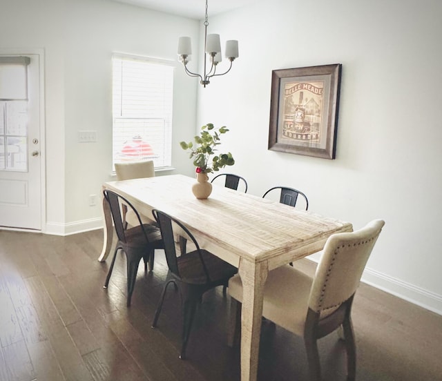 dining space with a chandelier and dark hardwood / wood-style floors