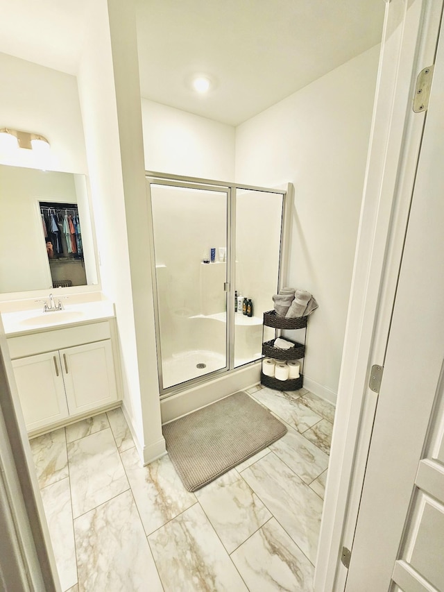 bathroom featuring vanity and a shower with shower door