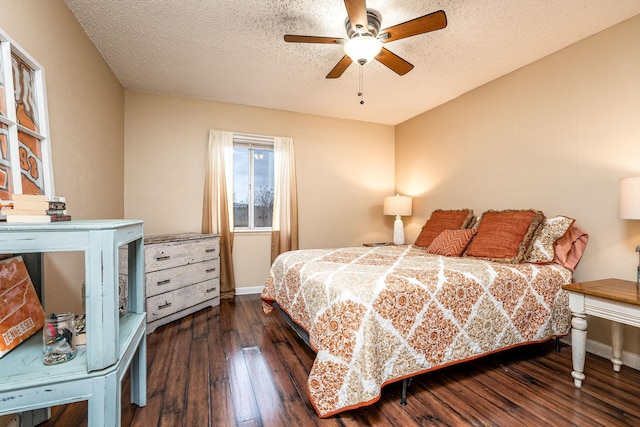 bedroom featuring ceiling fan, a textured ceiling, and dark hardwood / wood-style floors