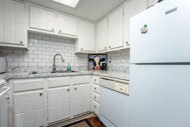 kitchen with white cabinets, decorative backsplash, sink, and white appliances