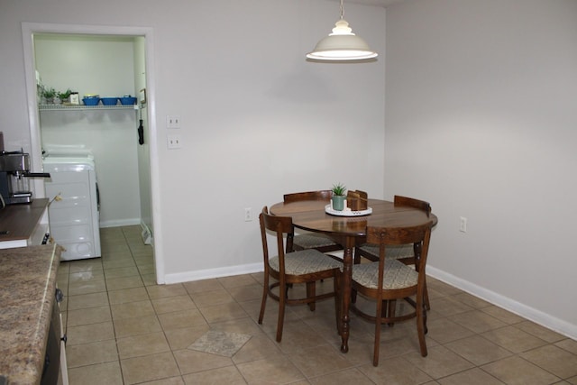 tiled dining space with washer / clothes dryer