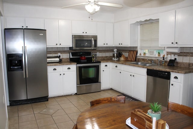 kitchen featuring white cabinets, backsplash, stainless steel appliances, and sink