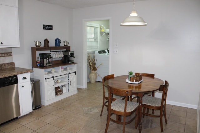 tiled dining room with washing machine and dryer