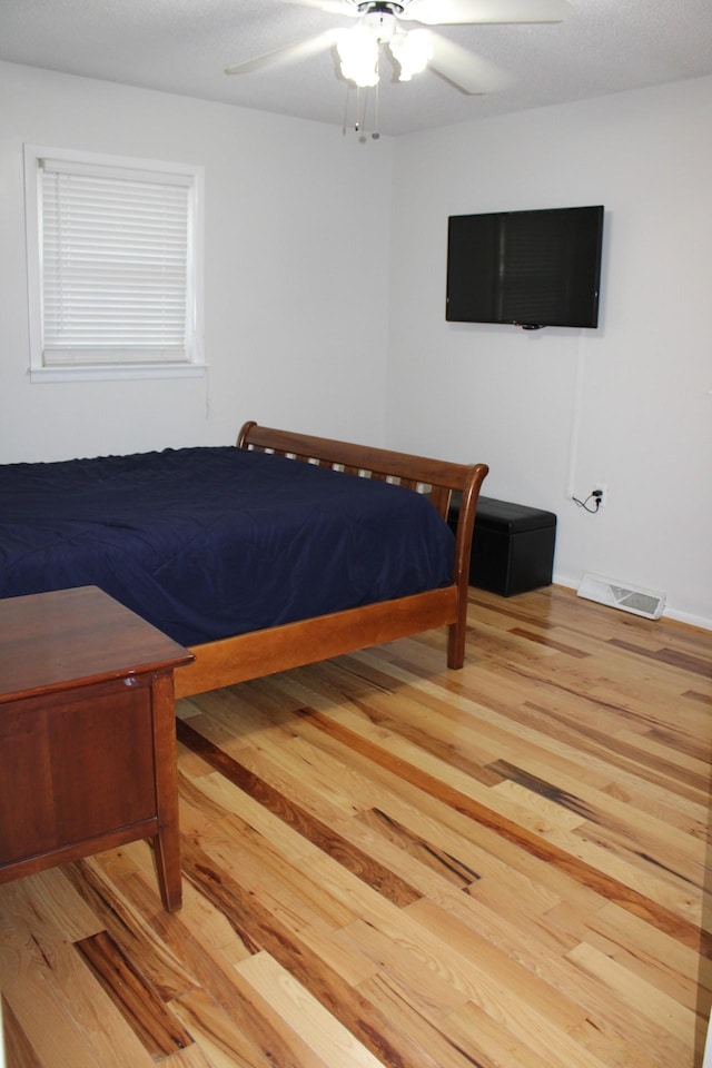 bedroom featuring hardwood / wood-style flooring and ceiling fan