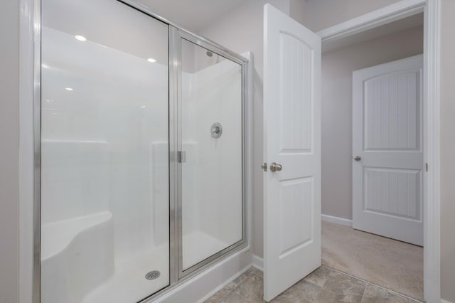 bathroom with a shower with shower door