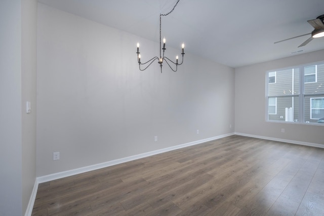 unfurnished dining area with hardwood / wood-style flooring and ceiling fan with notable chandelier