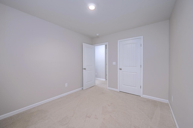 unfurnished bedroom featuring light colored carpet