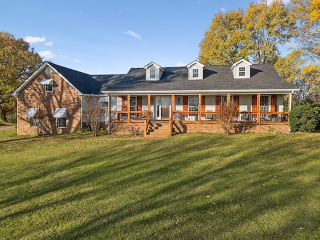 back of property with a yard and a porch