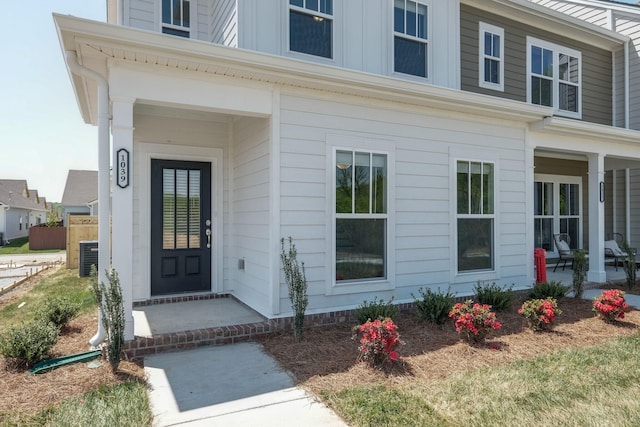 property entrance featuring cooling unit and covered porch