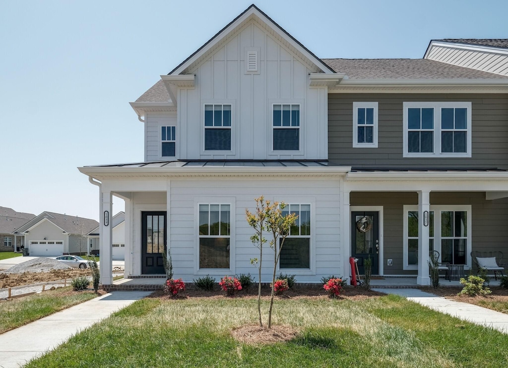 view of front of house with a porch and a front lawn