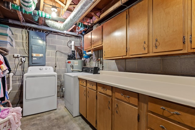 clothes washing area with cabinets, independent washer and dryer, electric panel, and water heater