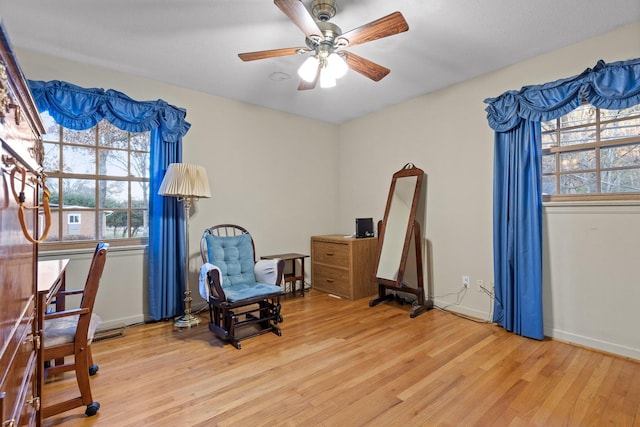 living area featuring ceiling fan and light hardwood / wood-style flooring