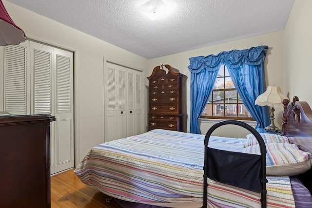 bedroom with hardwood / wood-style flooring and a textured ceiling