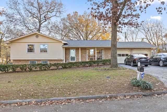 view of front of home with a garage and a front lawn