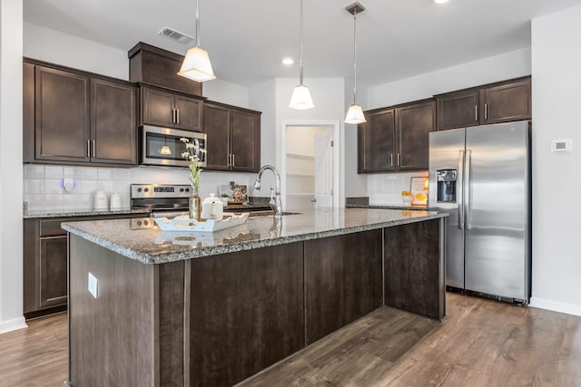 kitchen featuring sink, hanging light fixtures, dark hardwood / wood-style floors, dark brown cabinets, and stainless steel appliances