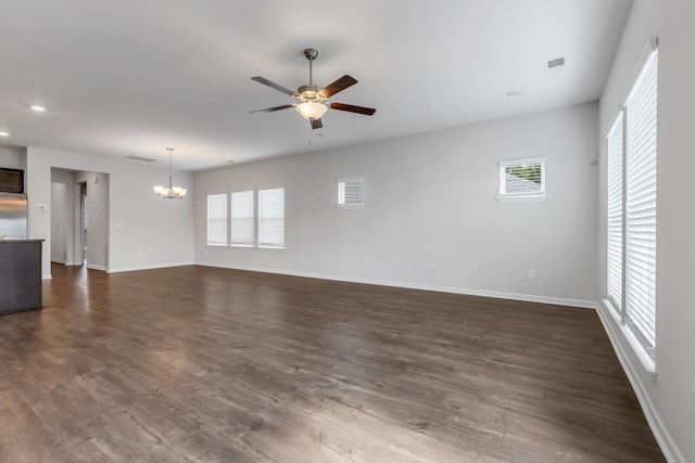 unfurnished living room with dark hardwood / wood-style floors and ceiling fan with notable chandelier