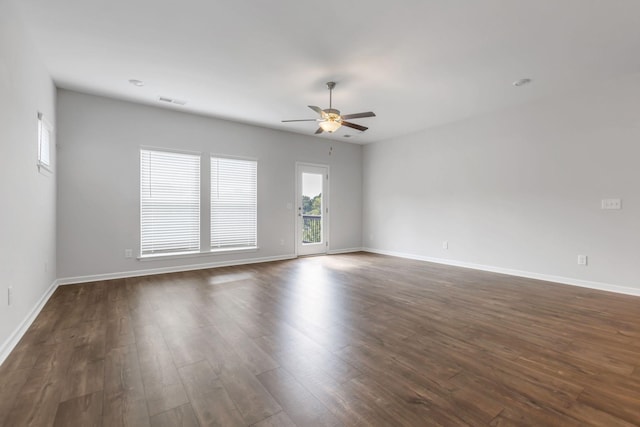 spare room with dark hardwood / wood-style floors and ceiling fan