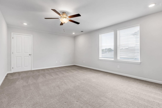 carpeted empty room featuring ceiling fan