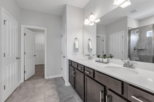 bathroom with tile patterned floors, vanity, and a shower with shower door