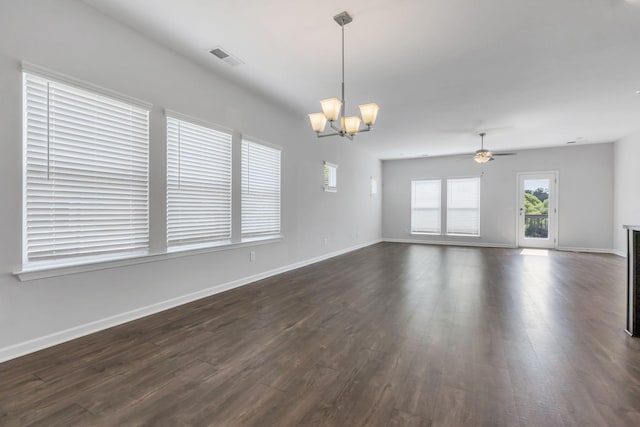 spare room featuring ceiling fan with notable chandelier and dark wood-type flooring