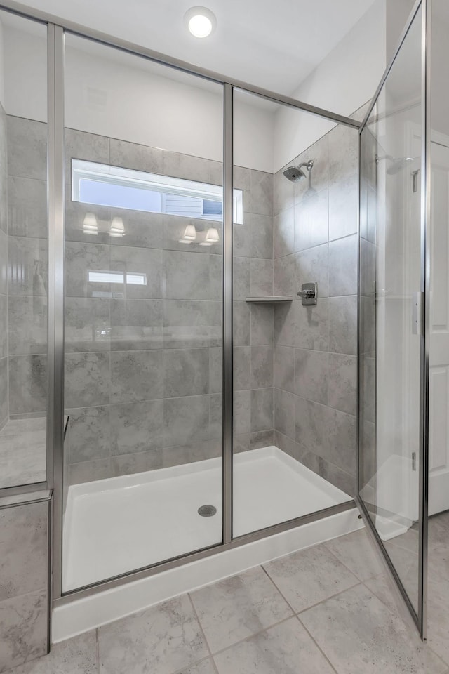 bathroom featuring a shower with shower door