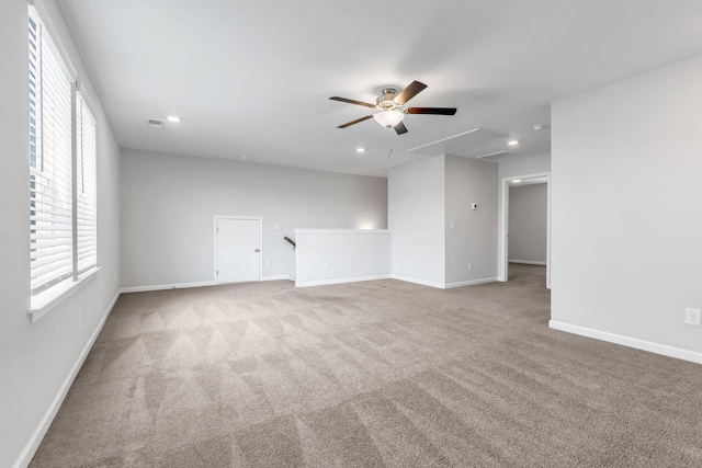 unfurnished room featuring ceiling fan and light colored carpet