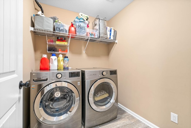 laundry area with hardwood / wood-style floors and separate washer and dryer