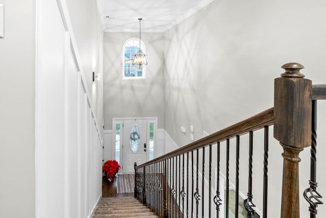 staircase with a chandelier and hardwood / wood-style floors