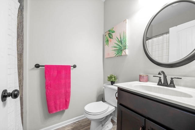 bathroom featuring vanity, hardwood / wood-style flooring, and toilet