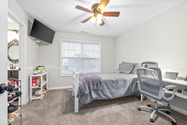 bedroom featuring carpet floors, ceiling fan, and sink