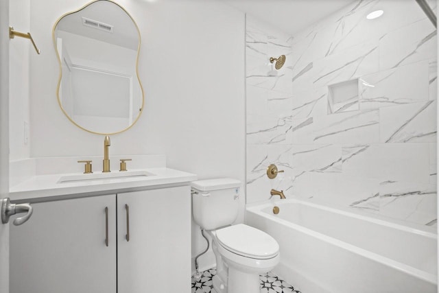 full bathroom featuring vanity, tiled shower / bath combo, and toilet