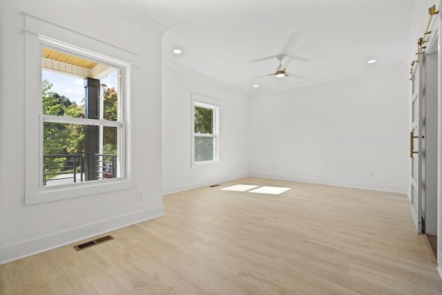 empty room featuring ceiling fan, light hardwood / wood-style floors, and ornamental molding