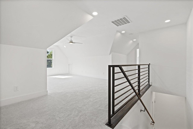 additional living space with carpet flooring, ceiling fan, and lofted ceiling