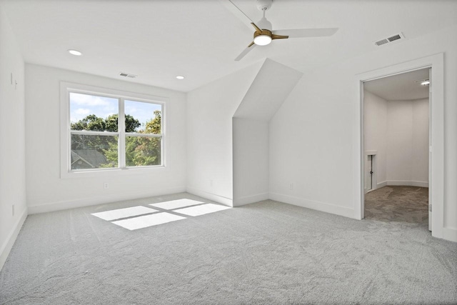 bonus room with ceiling fan and light colored carpet