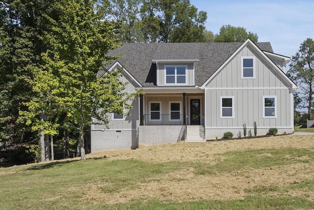 view of front of house featuring covered porch and a front yard