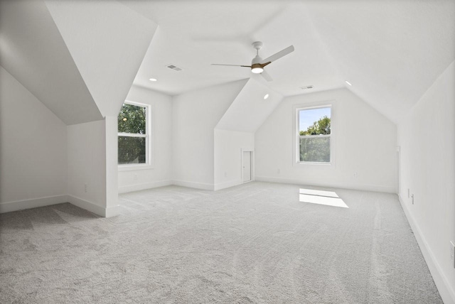 additional living space with ceiling fan, light carpet, and lofted ceiling