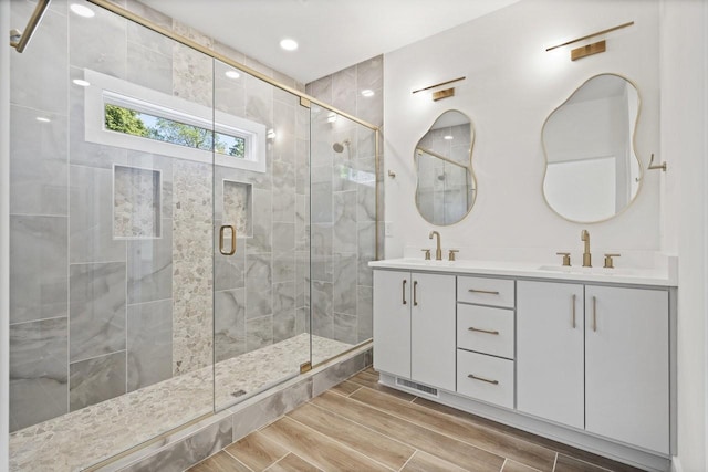 bathroom featuring vanity and an enclosed shower