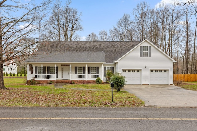 view of front of house featuring a porch, a garage, and a front yard