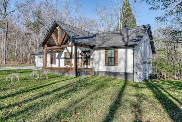 view of front of home with central AC, a front lawn, and a garage