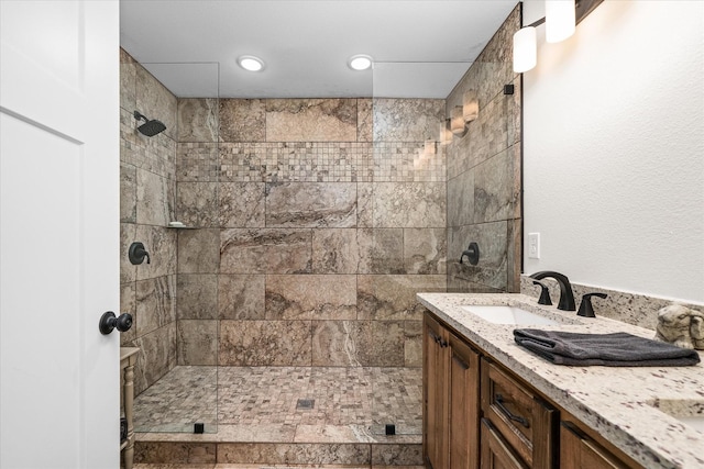 bathroom featuring vanity and a tile shower